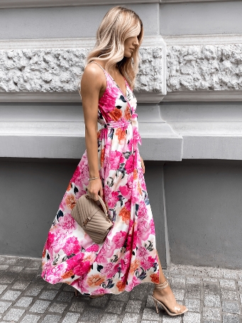 A young girl wearing a colorful long dress